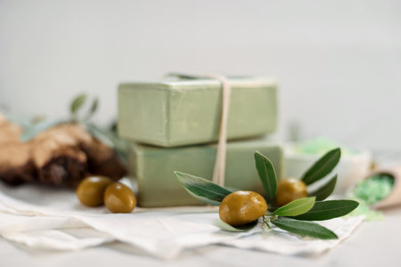 Natural soap bars and olives on white table, selective focusの写真素材