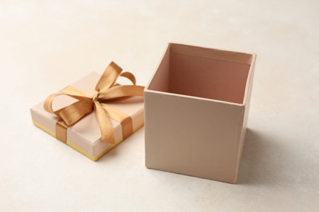 Open gift box with beautiful lid on light background