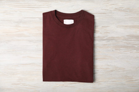 Brown t-shirt on wooden table, top view. Mockup for designの写真素材