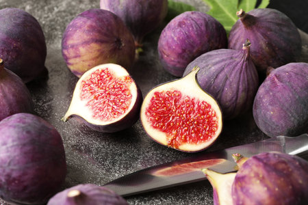 Fresh ripe figs and knife on table, closeup