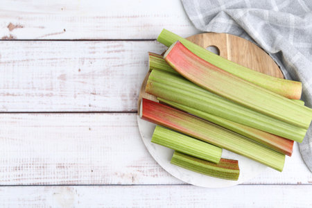 Rhubarb stalks on white wooden table, top view. Space for textの写真素材