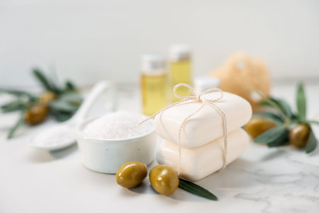 Natural soap bars, olives and sea salt on white marble table, closeupの写真素材