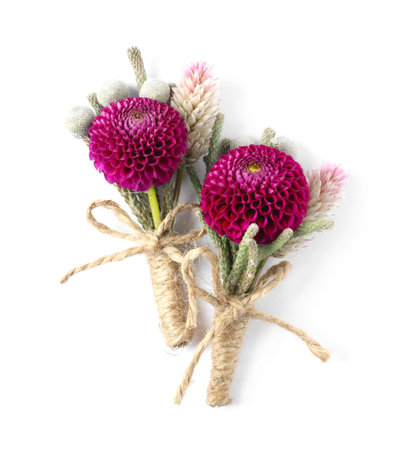 Stylish boutonnieres with flowers isolated on white, top view