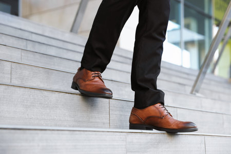 Man walking down stairs outdoors, closeup view