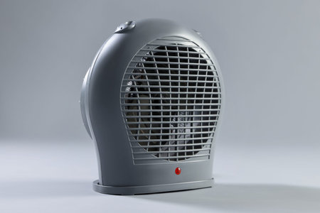 Modern electric fan heater on light gray backgroundの写真素材