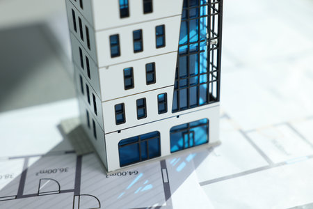 Real estate. Apartment building model and architectural drawings on table, closeupの写真素材