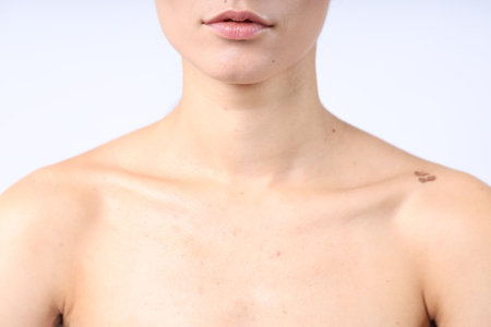 Woman with normal skin on light background, closeupの写真素材