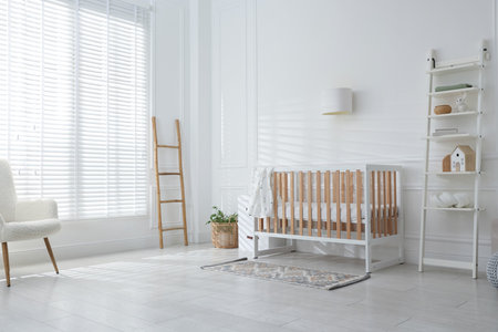 Stylish baby's room with crib and shelving unit. Interior designの写真素材