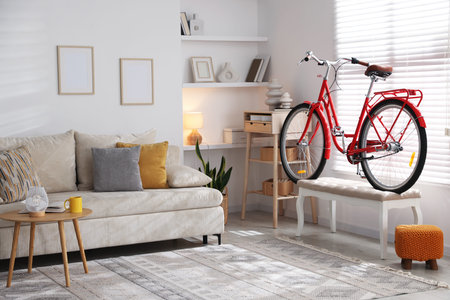 Red bicycle, sofa and decor in roomの写真素材