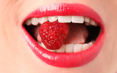 Woman with beautiful lips makeup and raspberry, closeup