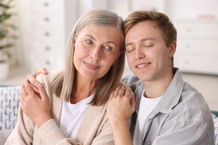 Happy son and his mother at home. Family bondingの写真素材