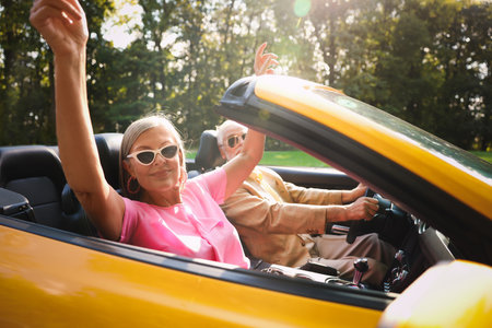 Senior couple enjoying cabriolet ride, selective focusの写真素材