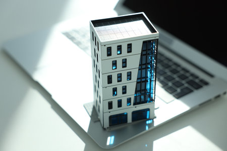 Real estate. Apartment building model and laptop on light table, closeupの写真素材