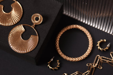 Stylish presentation of gold jewelry on black background, above viewの写真素材