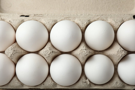 Raw chicken eggs in carton, top view