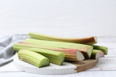 Rhubarb stalks on white wooden table, closeup. Space for textの写真素材