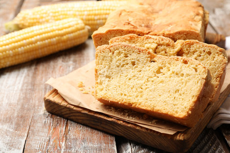 Freshly baked cut cornbread on wooden table, closeupの写真素材