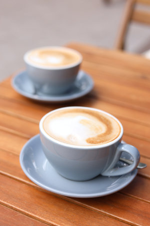 Cups of aromatic coffee on wooden table, closeupの写真素材