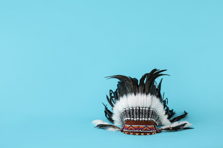 Traditional warbonnet (Native American chief headdress) on light blue background, space for textの写真素材