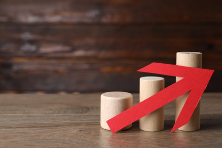 Risk. Wooden blocks and red arrow on table, space for textの写真素材