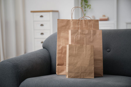Paper bags on sofa at home. Space for textの写真素材