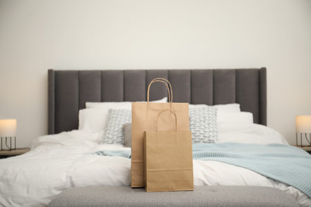 Paper shopping bags on bed at homeの写真素材