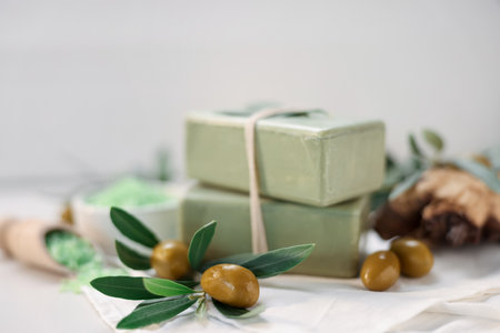 Natural soap bars and olives on white table, selective focusの写真素材