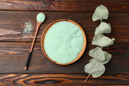Natural sea salt and eucalyptus on wooden table, flat layの写真素材