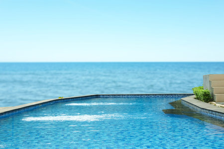 Swimming pool with clear water and view on ocean