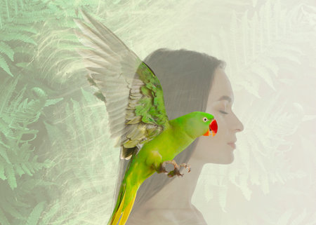 Beautiful young woman and parrot, multiple exposure with tropical leaves
