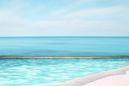 Swimming pool with clear water and view on oceanの写真素材