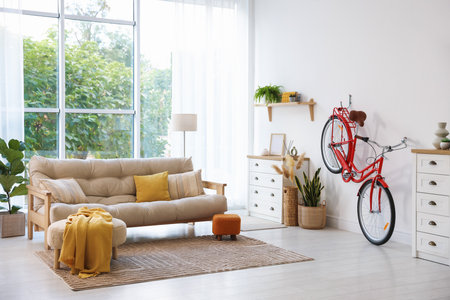 Red bicycle, furniture and houseplants in roomの写真素材