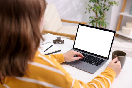 Woman working with laptop at white table indoors, closeup. Mockup for designの写真素材