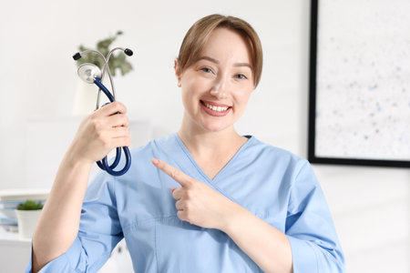 Portrait of professional nurse with stethoscope in officeの写真素材