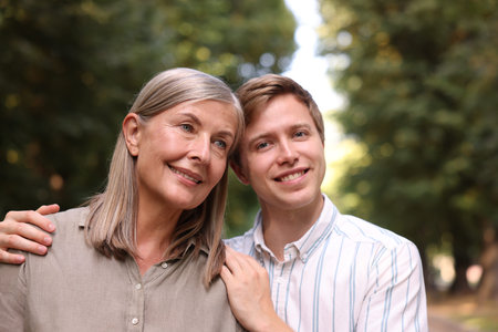 Smiling mother and her son outdoors. Family bonding