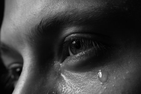 Closeup view of sad man crying. Black and white effectの写真素材