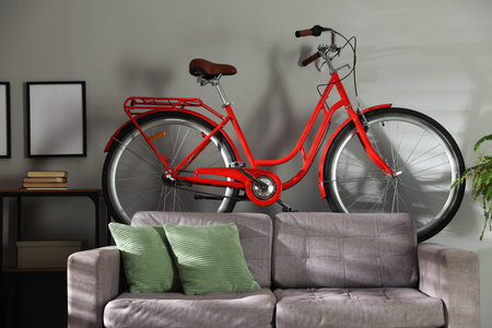 Red bicycle, sofa and console table indoorsの写真素材