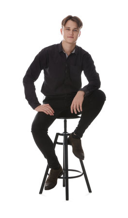 Man on stool against white backgroundの写真素材