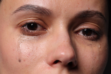 Closeup view of sad young woman cryingの写真素材