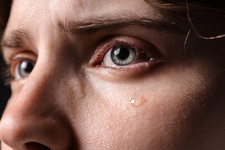 Closeup view of sad young woman crying