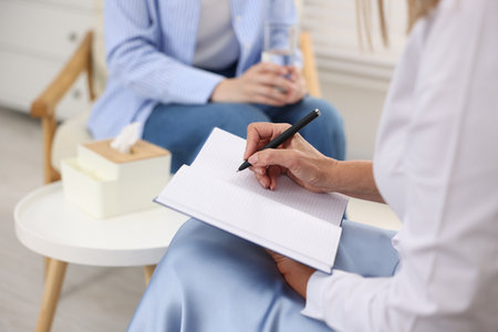 Professional psychotherapist working with patient in office, closeupの写真素材