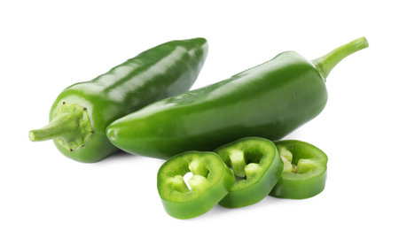 Whole and sliced green jalapeno peppers isolated on whiteの写真素材