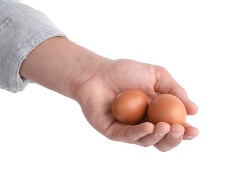 Person with raw chicken eggs on white background, closeupの写真素材