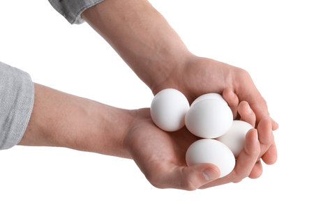 Person with raw chicken eggs on white background, closeupの写真素材