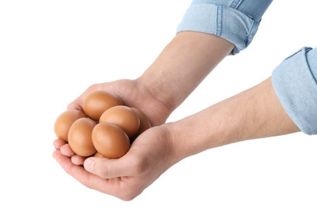 Person with raw chicken eggs on white background, closeupの写真素材