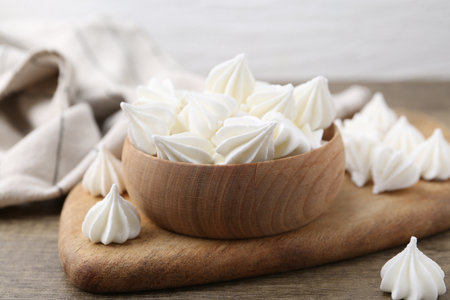 Delicious meringue cookies on wooden table, closeupの写真素材