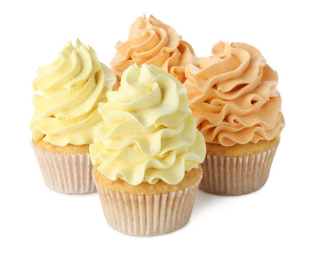 Delicious cupcakes with colorful cream isolated on whiteの写真素材
