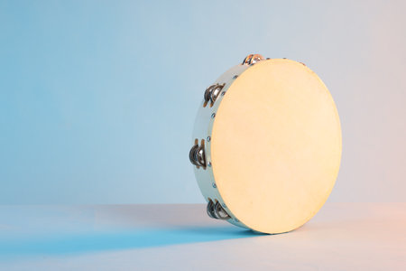 Tambourine on light blue background, space for textの写真素材