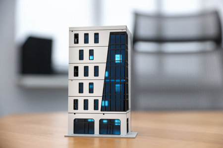 Real estate. Apartment building model on wooden table indoors, closeup