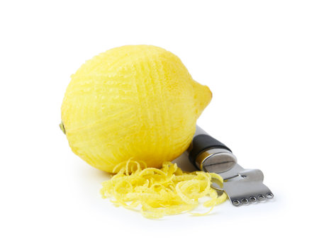 Lemon zest, fresh fruit and zester tool isolated on whiteの写真素材